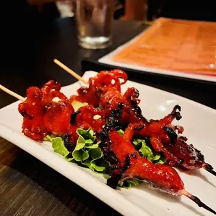 skewered meat on a white plate