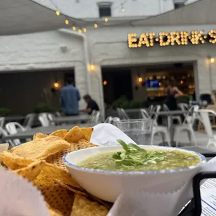 a bowl of guacamole and chips