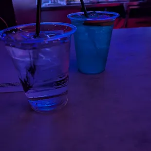 Water upfront and $18 blue magic cocktail behind