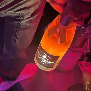 a person pouring a drink into a bottle