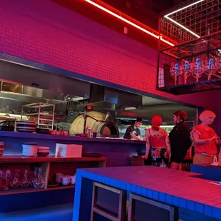 The open kitchen and a look at the bar, with height-appropriate counter/seats.
