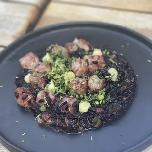 Black rice and scallop dish with citrus dollops