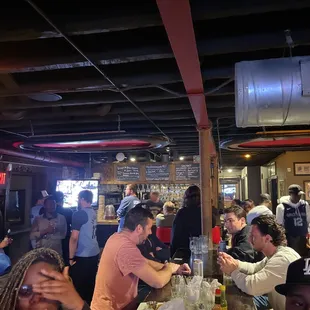 a group of people sitting at a bar