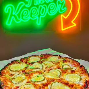 a pizza with cucumbers on it