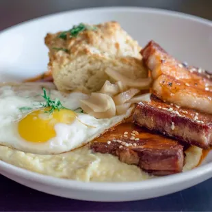 bacon, eggs, and grits on a plate