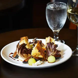 a plate of food and a glass of wine