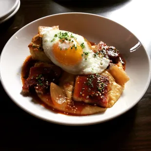 Pork Belly Biscuit with grits, pickled vidalias, hot sauce, and a fried egg