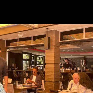 a group of people sitting at tables in a restaurant