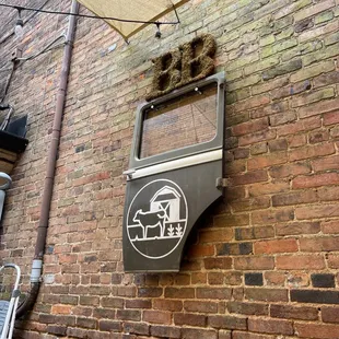 a sign on a brick wall