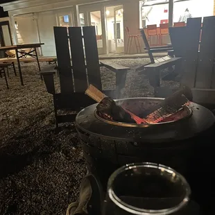 Courtyard area at night. Fires lit, bourbon in glass.