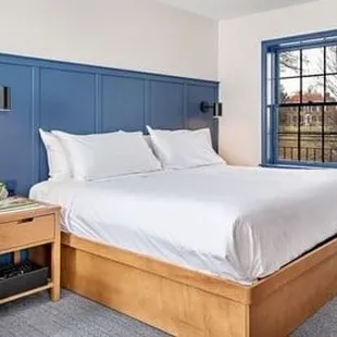 Bed and couch in room, plenty of space (stock photo)