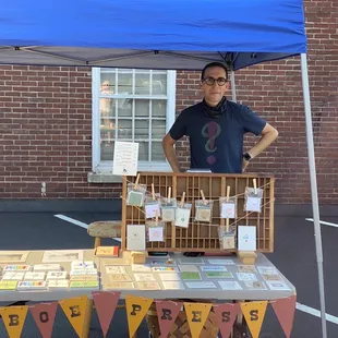 a man standing in front of his booth