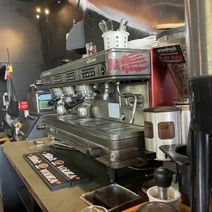 a coffee machine and a glass of water