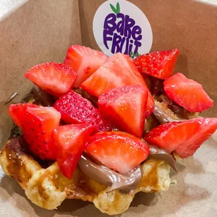 a chocolate covered waffle with strawberries