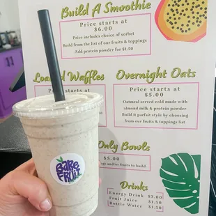 a hand holding a drink