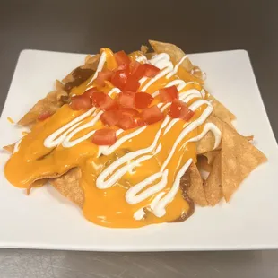 Nachos freshly made, chili and cheese sauce.