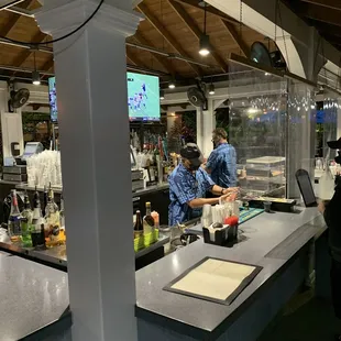 a man and a woman standing at the bar