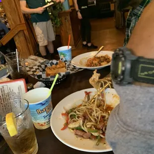 a man taking a picture of a plate of food