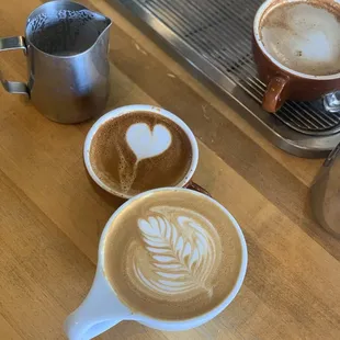 Latte art. One was mine and the other from the Barefoot barista. Of course you can see who did what