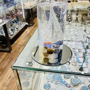 Assorted jewelry and sanitizer with stones in it. What a neat idea