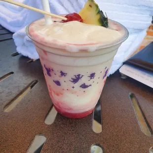 a smoothie with fruit on top