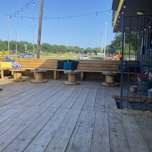 a wooden deck with benches and a stop sign