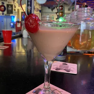 a martini with a cherry on top