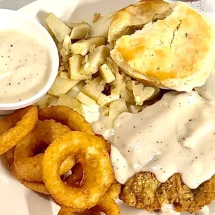Country fried steak and onion rings. Biscuit and gravy. German fries.