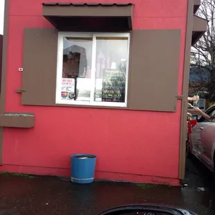 a pink building with brown shutters