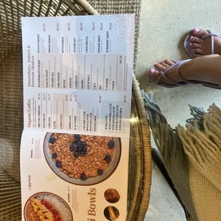 a menu and a person&apos;s feet