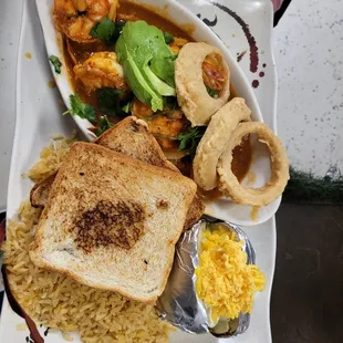 a plate of food with a sandwich and rice