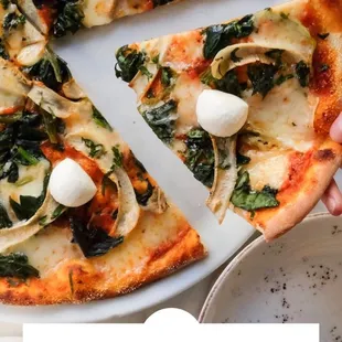 a person holding a slice of pizza