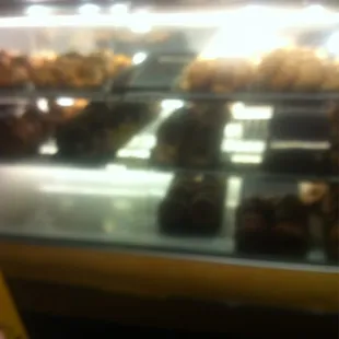 a variety of pastries in a display case