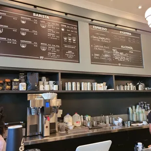 a man and a woman working at a coffee shop