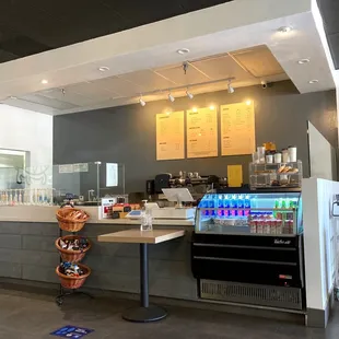 a coffee shop counter with a variety of drinks