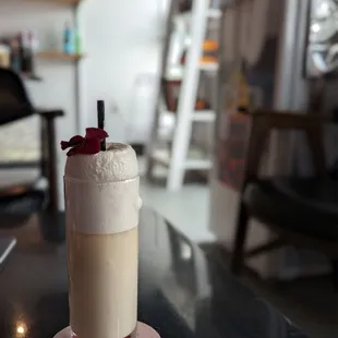 a drink in a tall glass on a table
