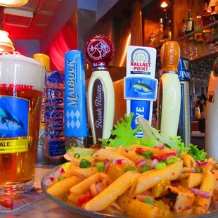 a plate of pasta and beer