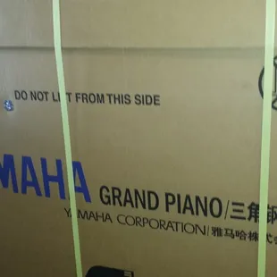 New Yamaha Grand piano in the box
