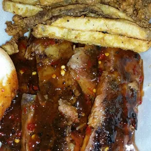 a plate of ribs and fries