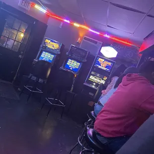 people playing video games in a bar