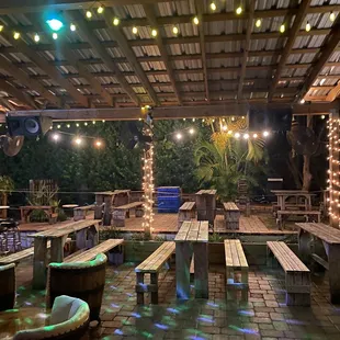 a patio with tables and benches