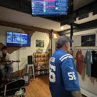 a man standing in front of a television