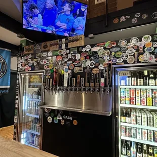 a bar with beer taps and a television