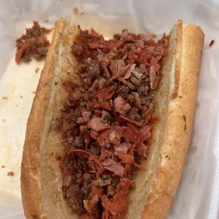 Meat lovers cheese steak sub, or kitchen staff was cleaning the pizza topping station.