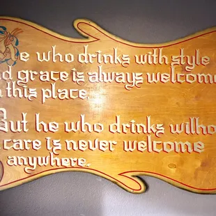 a wooden plaque with a quote on it