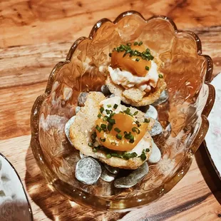 a plate of appetizers on a wooden table