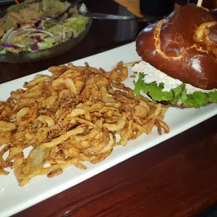 Chicken Salad Sandwich on a Pretzel Bun with onion straws