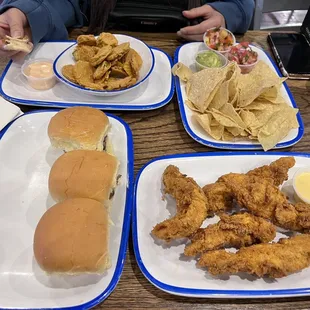 Sliders, chicken strips, chips and guacamole chips, fried pickle chips