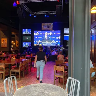 a woman walking through a bar