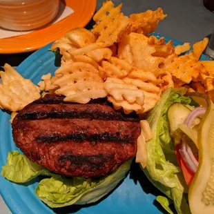 a hamburger and fries on a blue plate